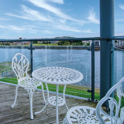 Relax on the private balcony overlooking the dock
