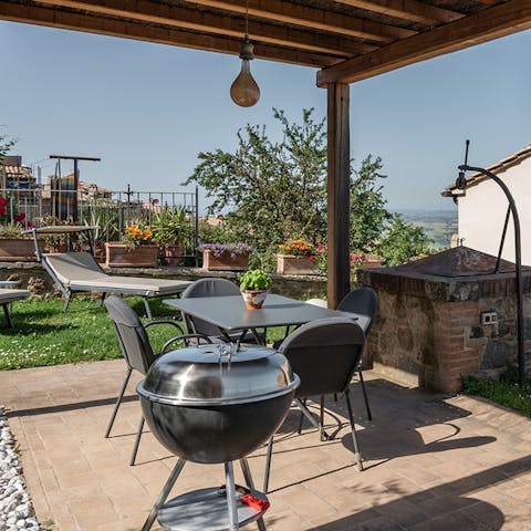 Fire up the barbecue for an alfresco feast under the gazebo