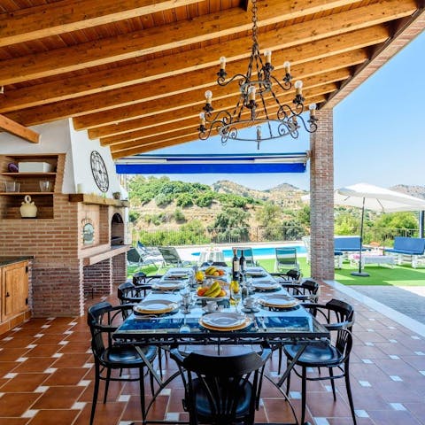Gather for a Spanish-style family celebration in the outdoor kitchen