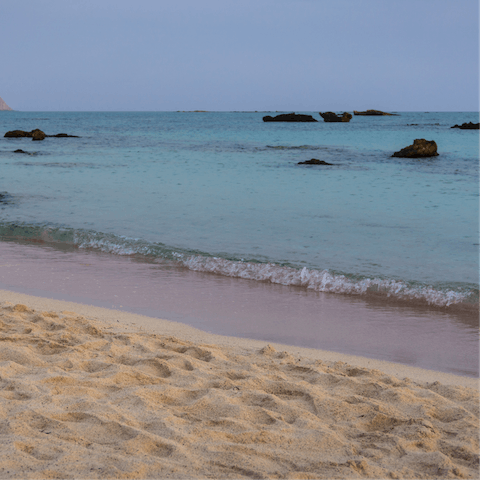 Paddle in the clear water of Paralia Kalives, a fifteen-minute drive away