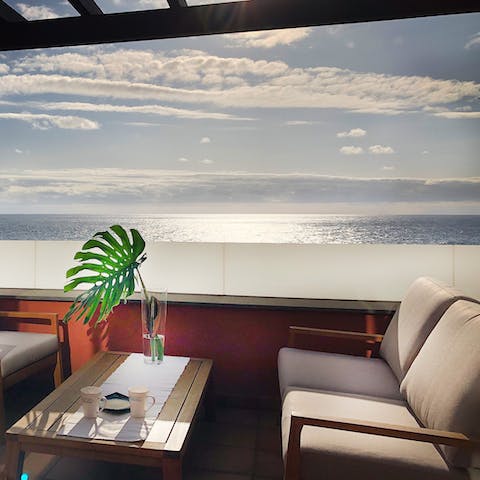 Watch the sun set over the water with a glass of wine in hand