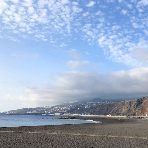 Stroll along the black sands of Santa Cruz de La Palma Beach, a ten-minute walk away