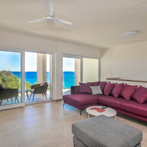 Relax in the living room with direct sea views
