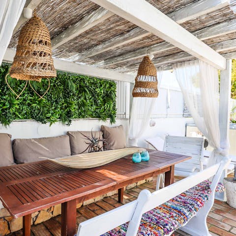 Tuck into alfresco family dinners under the pergola