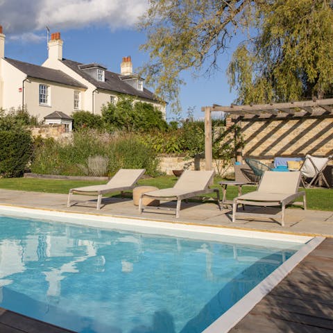 Spend long summer afternoon laying out on the loungers by the pool