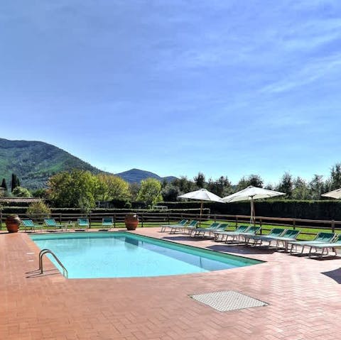 Lounge by the shared pool alongside mountain views
