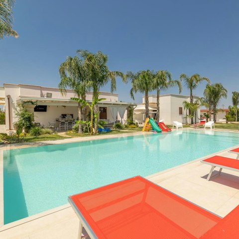 Stretch out by the pool while the little ones play nearby