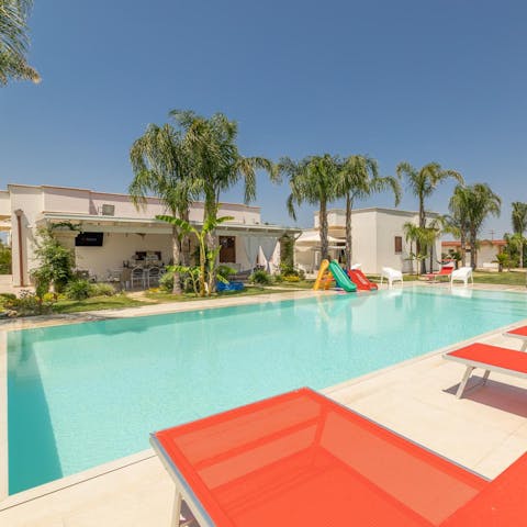 Stretch out by the pool while the little ones play nearby