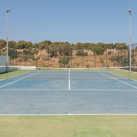 Practice your serve on the tennis court