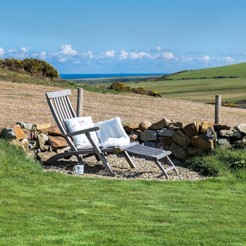 Take in the sea and Welsh countryside views from the garden