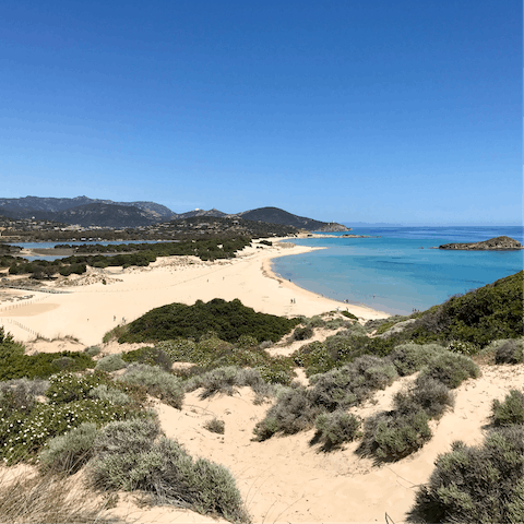 Visit the lagoon set back from Chia Beach, a flamingo breeding ground