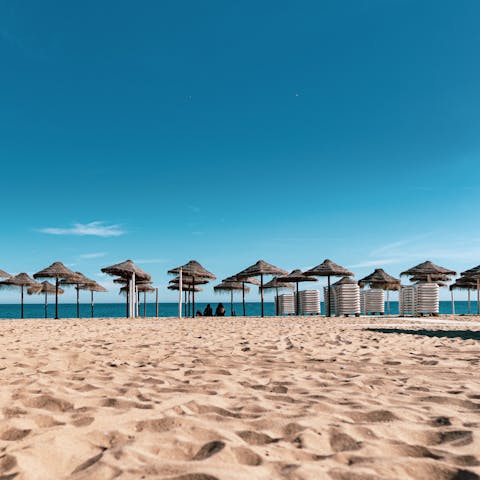 Watch the waves lap the shore on the sands of Playa de los Boliches