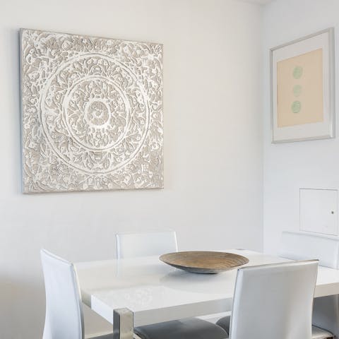 Sit down for a meal around the glossy white dining table