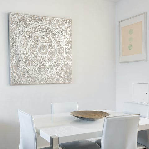 Sit down for a meal around the glossy white dining table