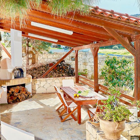 Sip Ouzo as the wood fired barbecue sizzles away