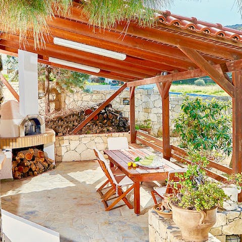 Sip Ouzo as the wood fired barbecue sizzles away