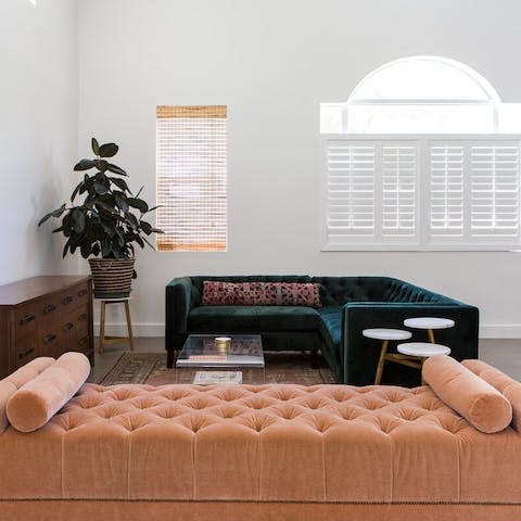 Take your pick from the pink or green velvet sofas