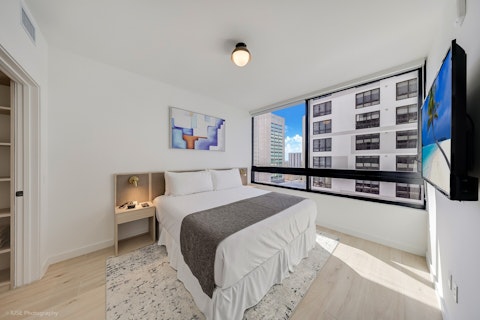 Wake up to city views through floor-to-ceiling windows