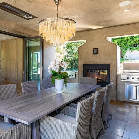 Keep the dinner party flowing beside the outdoor fireplace