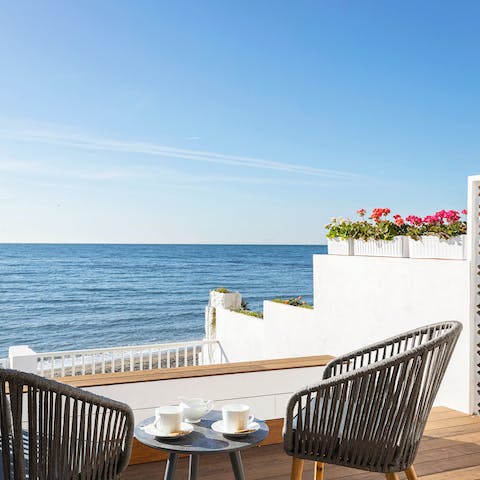 Enjoy your morning café con leche while watching the golden light reflect on the sea