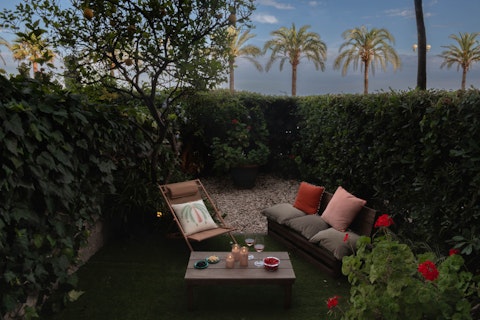 Unwind among lemon trees as the sun drops over the palms