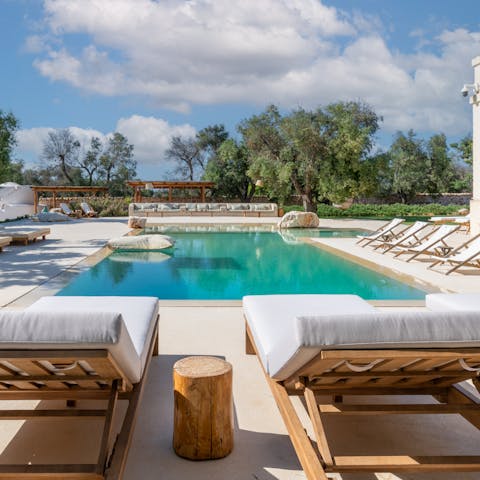 Settle back on a lounger in the chic pool area