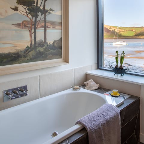 Enjoy a relaxing soak in the en-suite bathtub with views over the creek