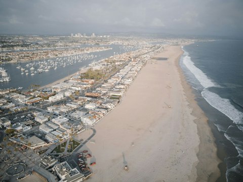 Swim and sunbathe along the Balboa Peninsula's Pacific shoreline, a fourteen-minute drive
