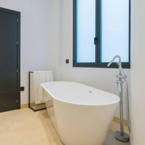 Slip into the freestanding bath after a long day on your feet
