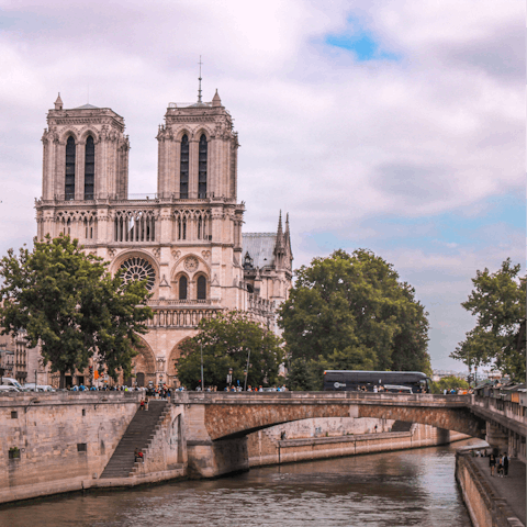 Stroll across Pont au Double and admire the iconic Notre-Dame