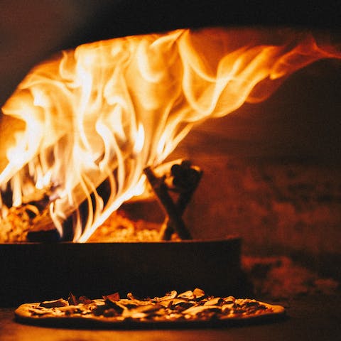 Dine alfresco on fresh pizza straight from the wood-burning oven