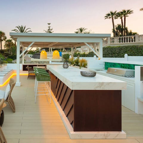 Mix up a round of sundowner cocktails at the rooftop bar