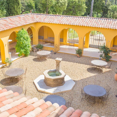 Dine around the fountain on the home's pretty courtyard
