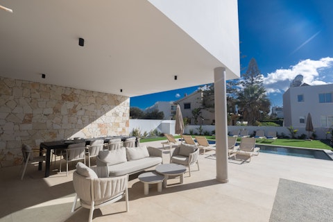 Lounge under the shaded terrace with a glass of wine in hand