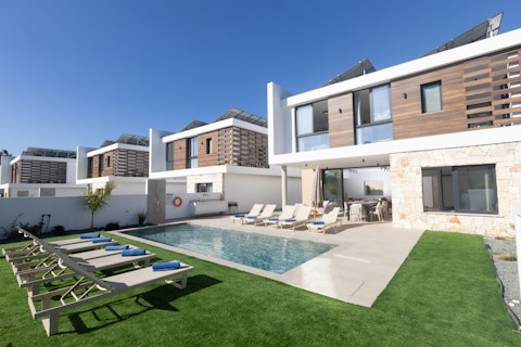 Stretch out on sun loungers beside your own private pool