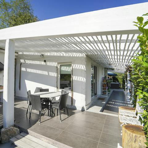 Play cards and sip sundowners while sat around the alfresco table on the covered terrace