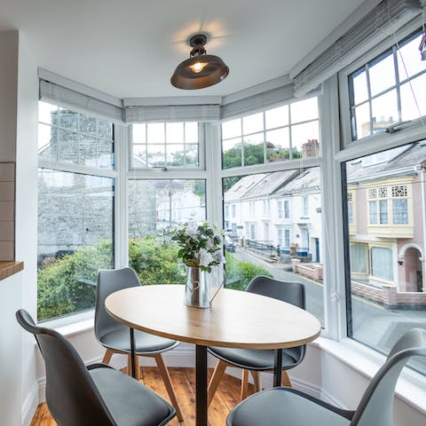 Dine in the bright bay window with pretty village views