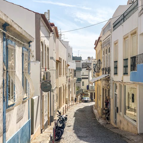 Wander the sunny streets of Lagos, just a ten-minute drive away