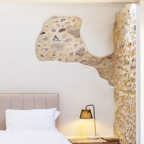 Fall into a peaceful sleep in the original flint and stone walled bedroom