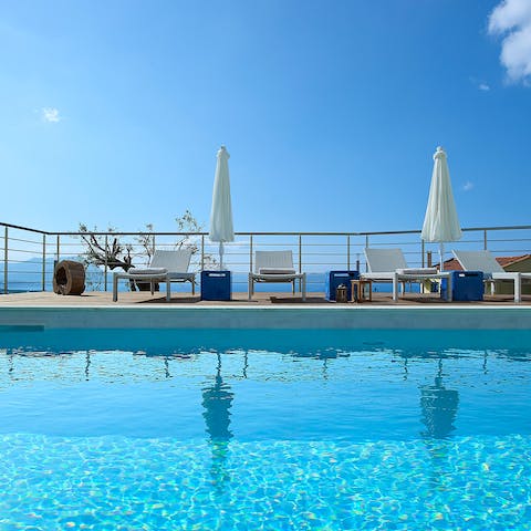 Lounge by the private pool with panoramic views over the mountains