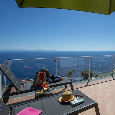 Take in majestic blue vistas over the Mediterranean Sea from the loungers