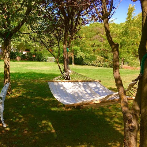Soak up the sun under the trees in one of the hammocks
