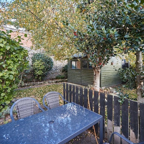 Dine alfresco beneath the holly tree on summer evenings