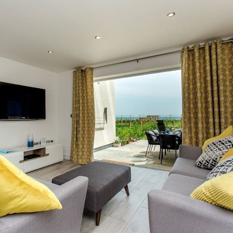 Throw open the glass doors and let the sea breeze refresh the living room