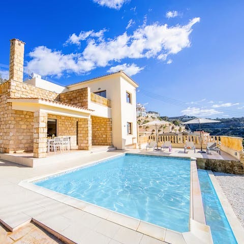 Swim in the pristine pool under the glow of the summer sun