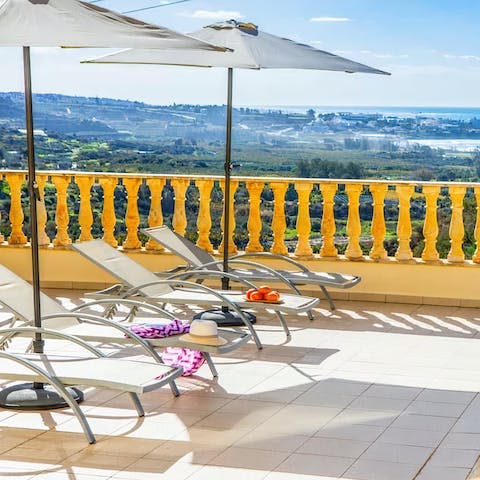 Lounge on the sun beds with a glorious view of the sprawling scenery