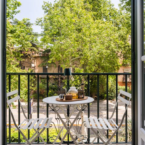 Take in the views over the leafy street with a glass of Sicilian wine
