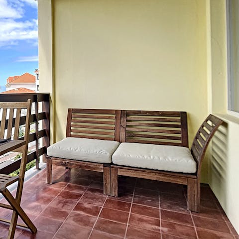 Relax on the outdoor seat, catching up on your current read while enjoying the peaceful sea view