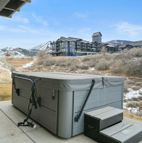 Soak in the hot tub with snow-dusted peaks ahead