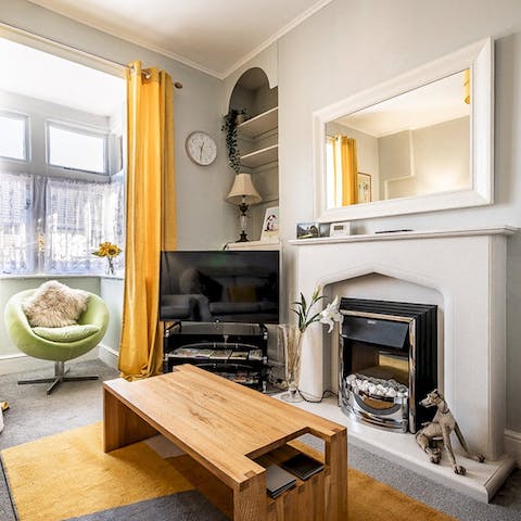 Put your feet up on the sofa and relax by the fireplace